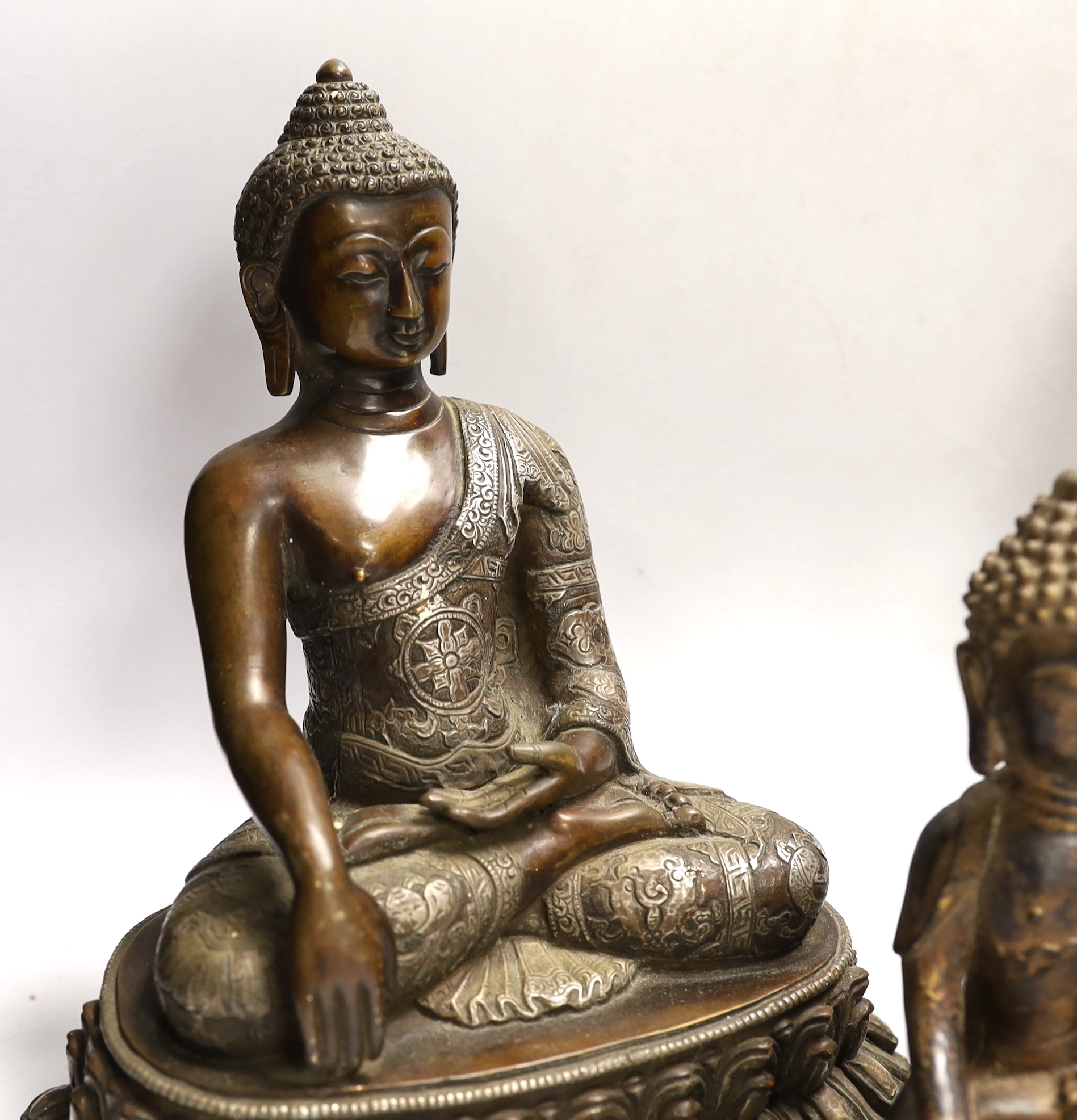 Four Thai and far-eastern bronze figures of the Buddha, tallest 28cm